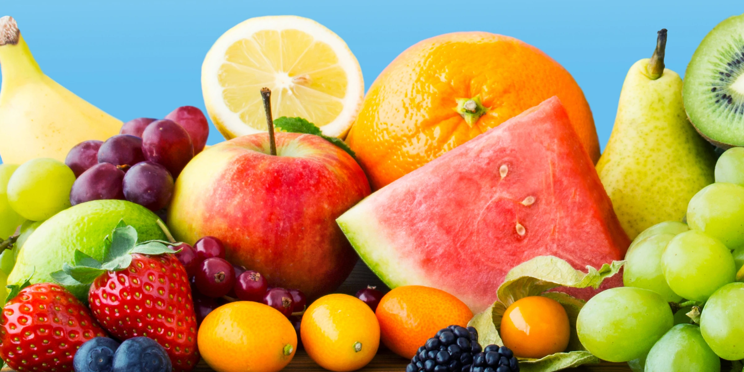 A variety of fruits that help develop Antioxidants including Banana, Grapes, Limes, Lemons, Oranges, Pears, Watermelon, Strawberries, Blueberries, Cranberries and Tomatoes on a blue background.
